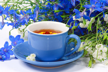 The blue cup of tea with nice flowers