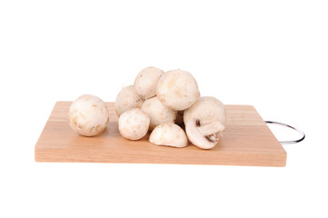 mushrooms on the cutting board isolated on the white background