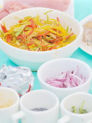 closeup view of white dishes with raw food on table