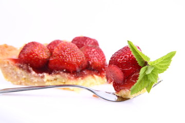 Strawberry Tart portion, a bite on a fork, on a white