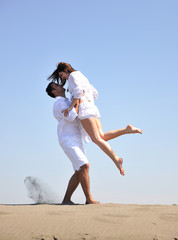 happy young couple have fun on beach