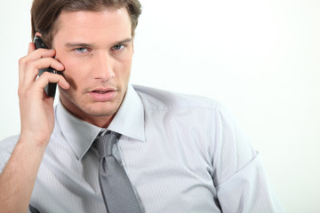 Fototapeta premium Young businessman on telephone