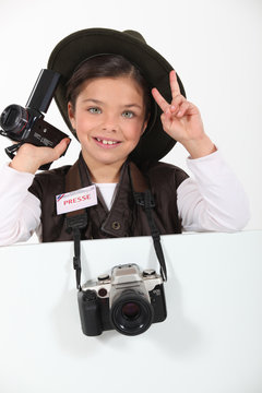 little girl dressed as a adventure reporter