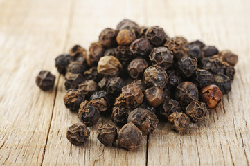 black pepper on wood background