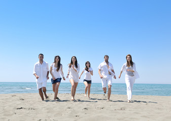 happy young  people group have fun on beach