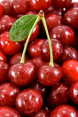Cherry fruits with leaf on the heap of cherry.