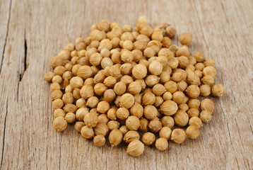 coriander seeds on wood background