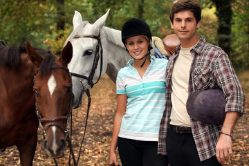 Horseback riders with their horses