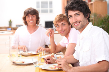 Obraz na płótnie Canvas Three young men having lunch
