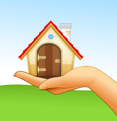 Woman’s hand is holding small house