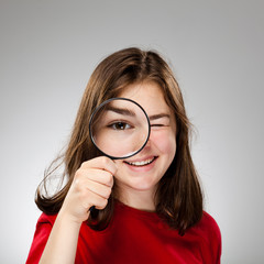 Girl holding magnifying glass