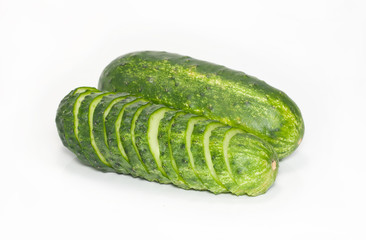 Cut and whole green cucumbers