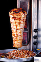 Doner kebab with tray of sliced meat