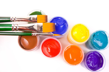 Some paints on white bacground with brushes