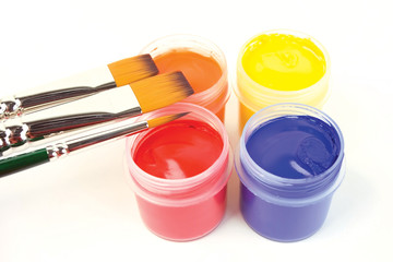 Paints in a bucket with paintbrushes