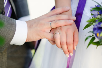 close-up of caucasian couple's hands with wedding rings