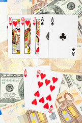 Playing cards over banknotes