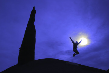 Hiker jumping for joy.