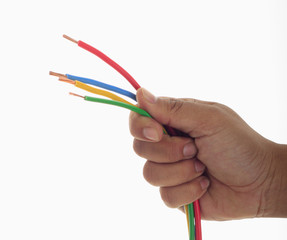 man's hand holding few electrical wire