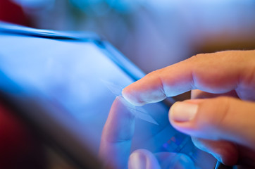 Close up of mans finger touching digital tablet screen