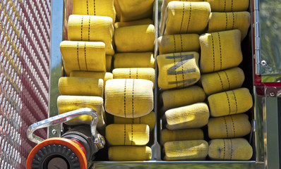 Up close view of a yellow fire hose on a firetruck