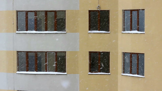 Snowing against the window of an modern house background