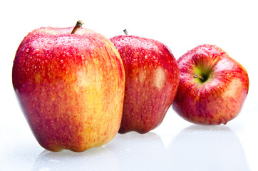 Three juicy apples lay in a number on white background