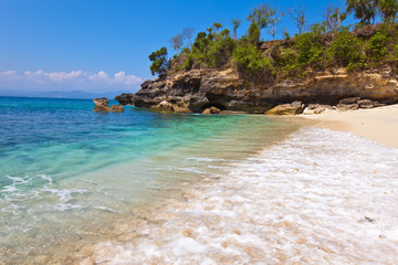 Fototapeta na wymiar View from a sandy beach on rocks at ocean.Indonesia,Bali..