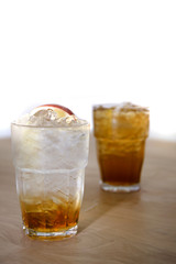 ice soda apple on wood and white backgrounds