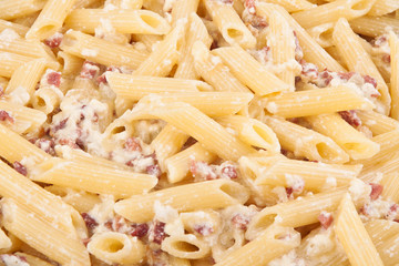 Closeup of pasta with bacon and cheese