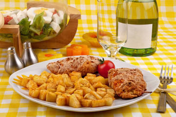 Chicken breast with fried potatoes and salad