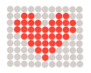 red heart shape made with white and red round pills