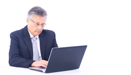 Senior business man working on laptop