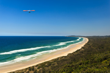 Hang Glider Flying Over Beach in Byron Bay AU