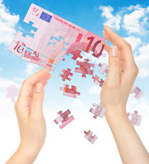 Hands and puzzle out of the money EURO