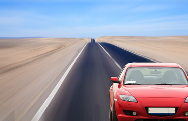 Fototapeta na wymiar Red car on desert road