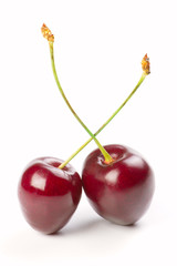 Fototapeta na wymiar Two red cherries isolated on a white background
