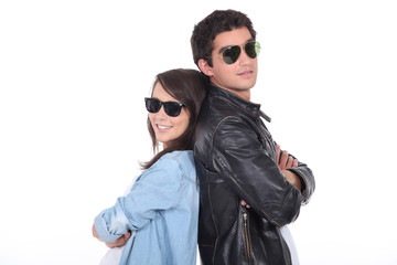 Young couple wearing sunglasses and trendy clothing