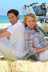 couple on the beach with bikes