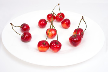 Obraz na płótnie Canvas Sweet cherry on white plate