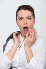 Young businesswoman shocked expression on face