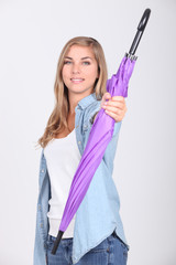Teenage girl holding purple umbrella