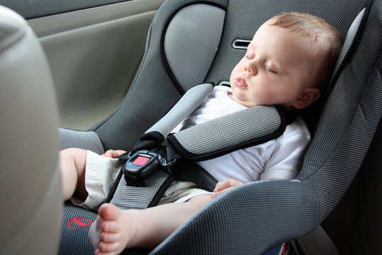 beautiful baby sleeping in car seat