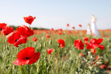 mother and daughter on poppy field