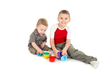 Children play with color toys.  isolated, a white background