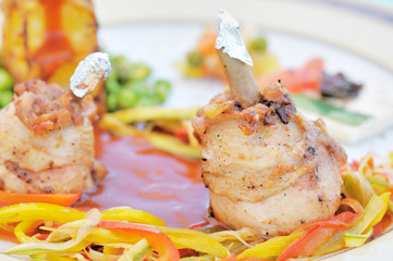close-up of a meal with fried drumsticks and vegetables