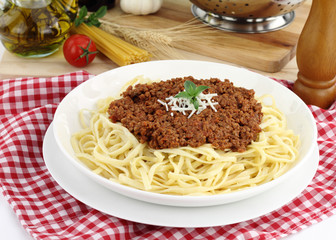 Bolognese pasta with cheese and basil