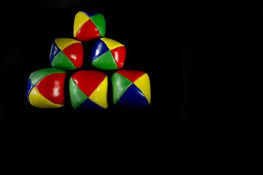 Pyramid juggling balls on a black background