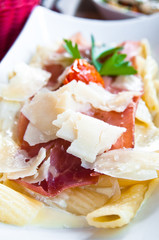 tasty pasta with roast ham on the table