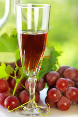 Glass of rose wine and mature grapes.